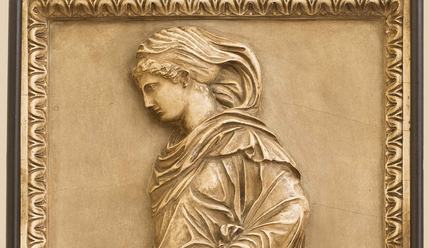A section of the Gradiva wall relief featuring her shoulders and head.