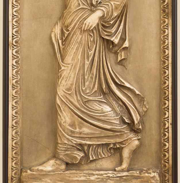 A section of the Gradiva wall relief featuring her hands and feet.