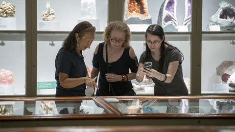Three museum guests enjoy the galleries.