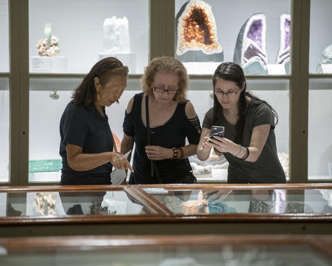 Three museum guests enjoy the galleries.
